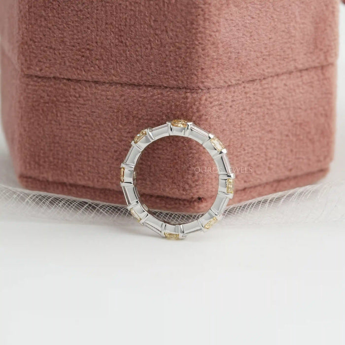 side view yellow cushion and baguette man made diamond eternity band white gold