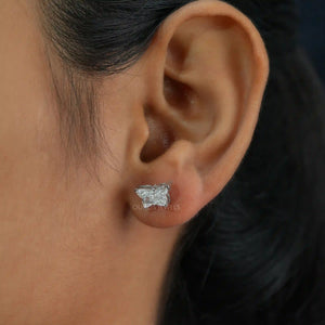 Butterfly Cut Diamond Stud Earrings worn on an ear, highlighting the elegant design and sparkling diamonds.