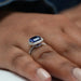 side view of blue cushion cut lab diamond halo engagement ring in finger