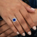 blue cushion cut lab diamond halo engagement ring on model's finger