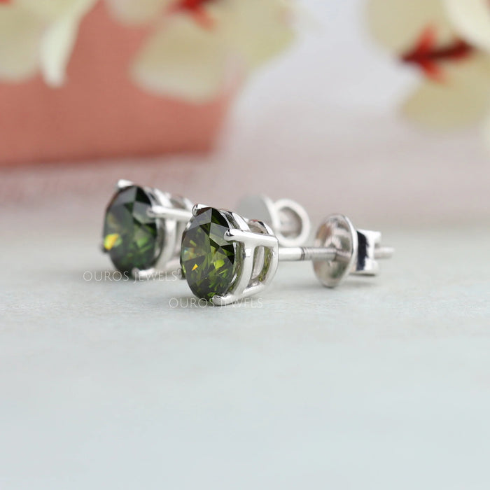 side view of green round cut lab diamond stud earrings white gold