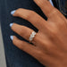 three stone hexagon cut lab diamond bezel set engagement ring on model's finger