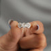 close view of three stone hexagon cut diamond bezel set engagement ring