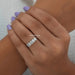 oval cut lab diamond five stone wedding ring on model's finger