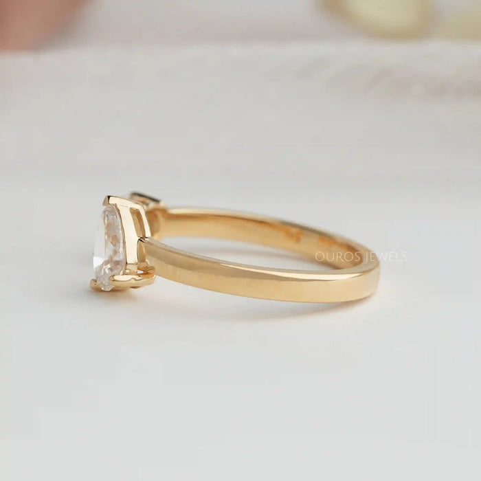 side view of pear and round-cut lab-grown diamond open cuff wedding band