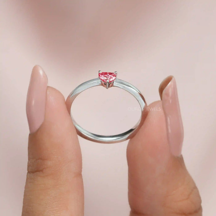 close view of pink heart shape lab diamond solitaire engagement ring
