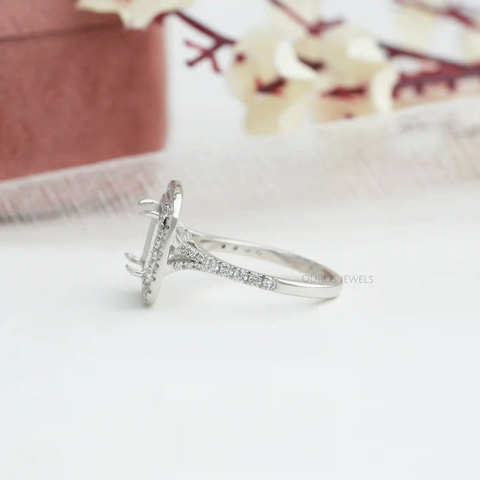side view of princess-cut semi-mount double halo engagement ring on fabric