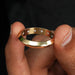 round cut hidden men's gold diamond wedding band between two finger