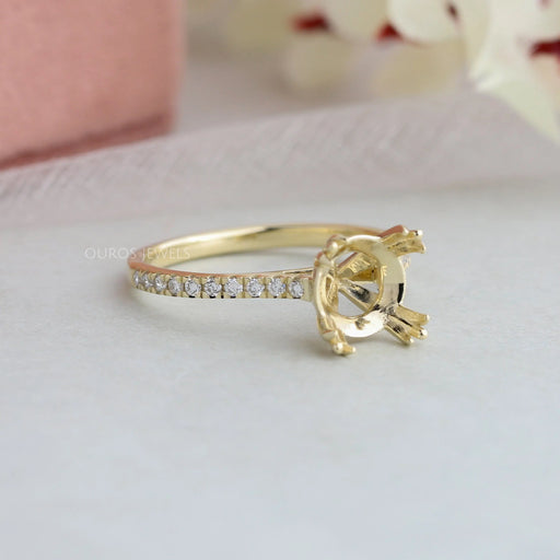 side view of solitaire accent diamond semi-mount engagement ring on grey fabric