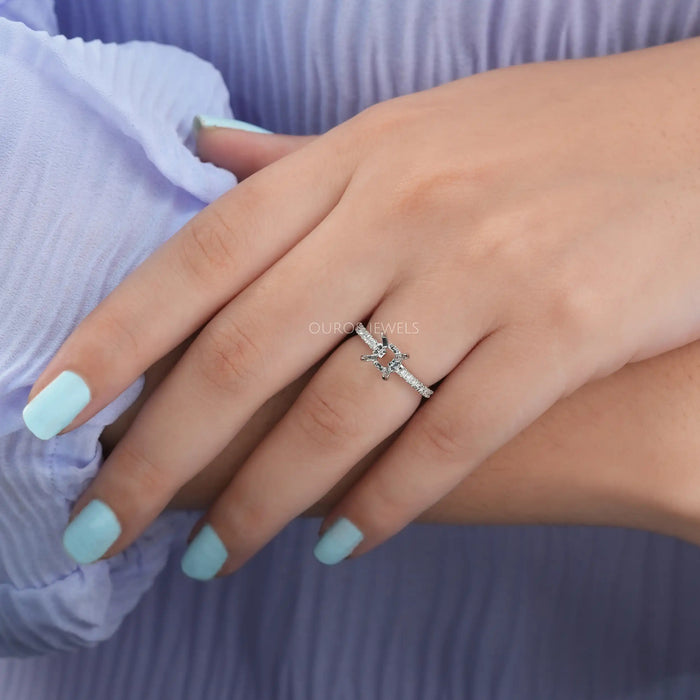 round-shaped hidden halo semi-mount engagement ring in finger