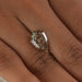 step cut pear shaped man made diamond on hand