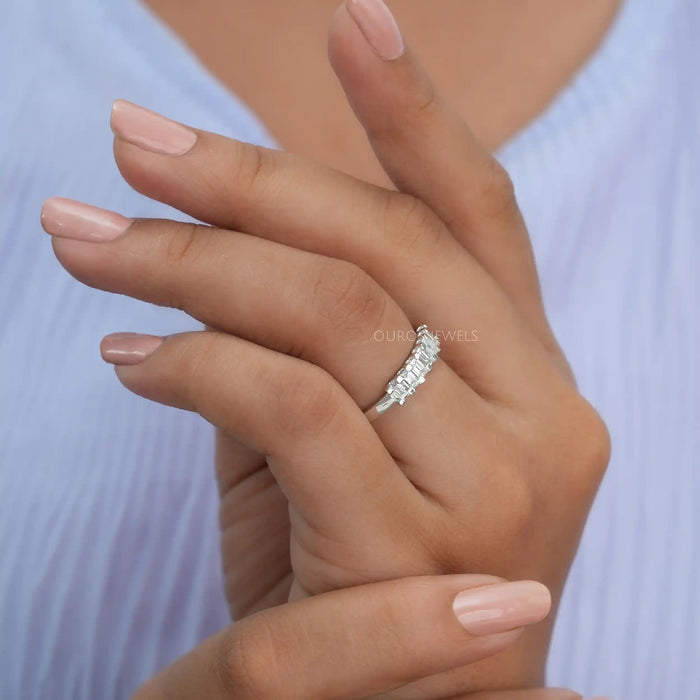 In finger side look of emerald lab made diamond wedding band