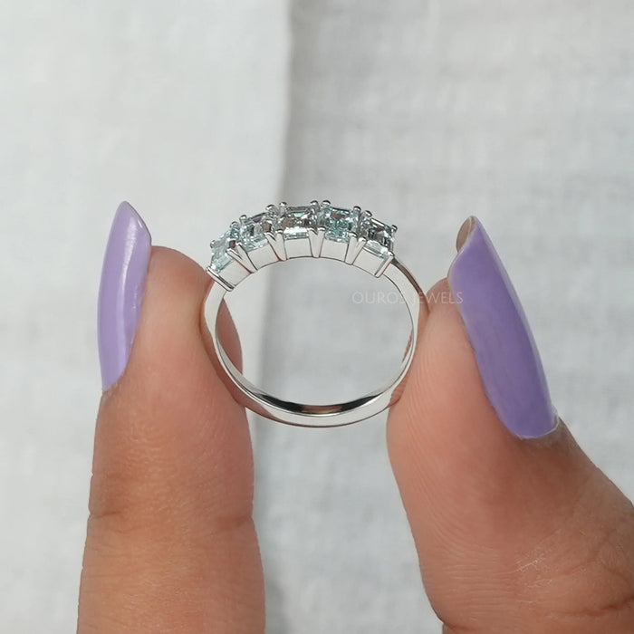 close view of light blue emerald cut lab diamond five stone wedding ring