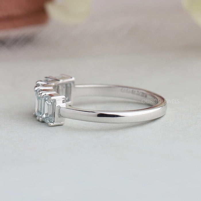 side view of light blue emerald cut lab diamond five stone wedding ring