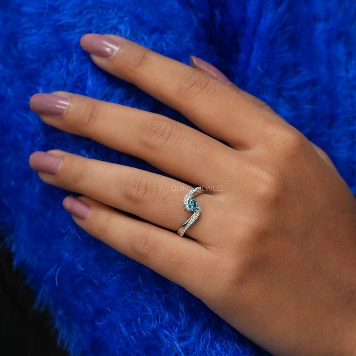 Front view of blue heart shaped set in solitaire engagement ring, this ring crafted in 14k white gold.