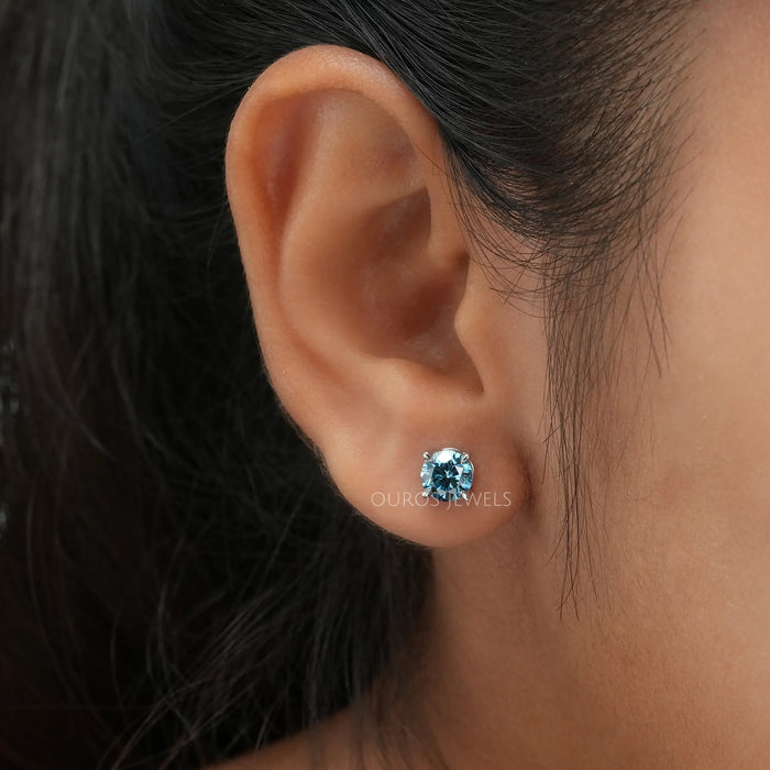 blue round cut diamond 4 prong setting solitaire stud earrings white gold in ear