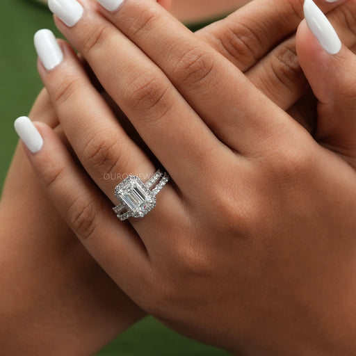 emerald cut lab diamond halo engagement ring on model's finger