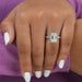 emerald cut lab diamond halo engagement ring in finger