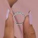 close view of emerald-cut lab diamond five-stone wedding ring with white gold band