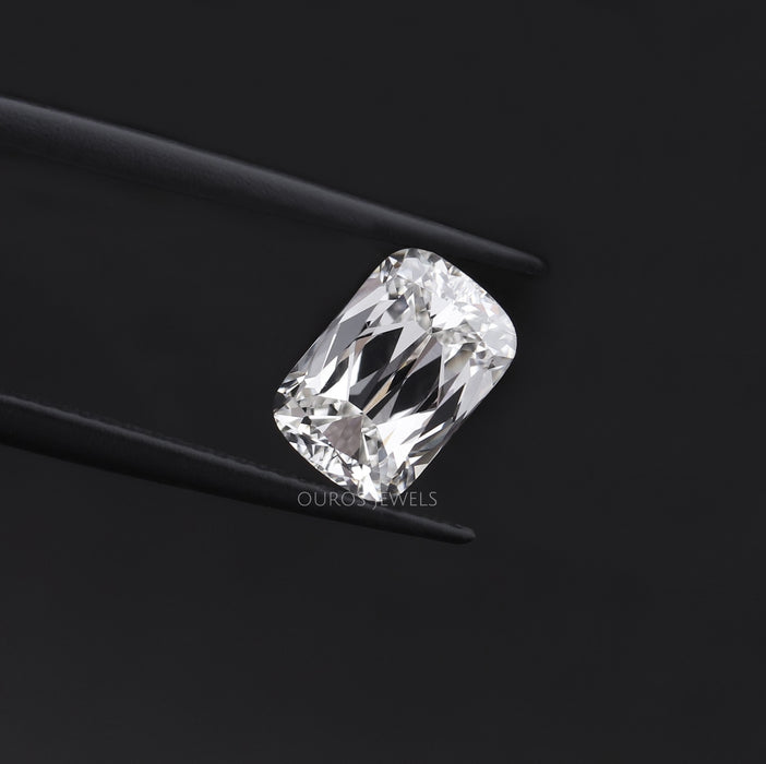 Sparkly 2.23 Carat IGI Certified Criss Cut Lab Diamond hold by tweezers against dark background.