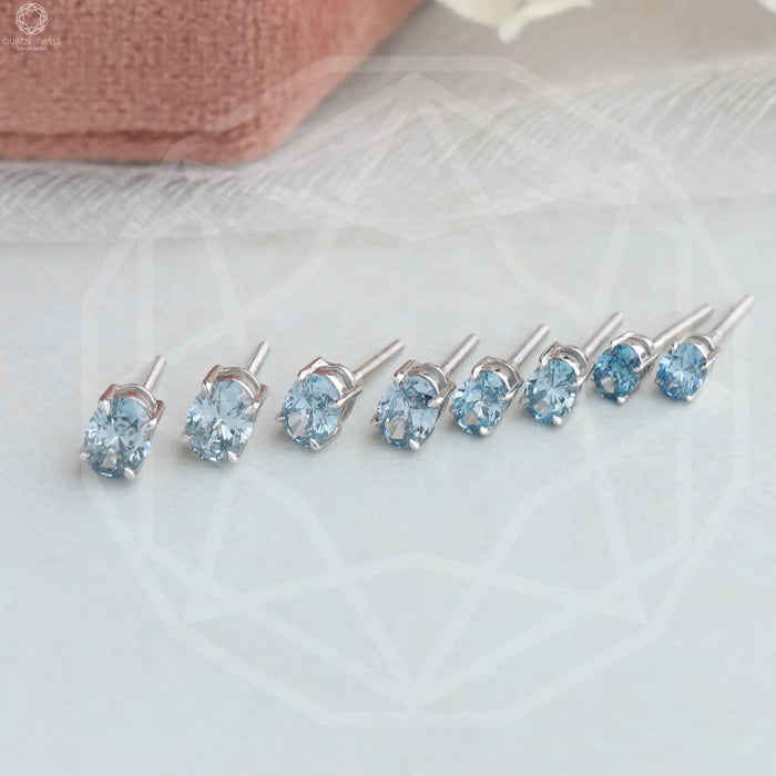 side view of blue oval cut manufactured diamond studs earrings white gold
