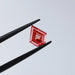 fancy pink kite shaped diamond lab grown loose held with tweezer