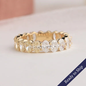 Yellow oval cut lab grown diamond eternity wedding band in 14k yellow gold