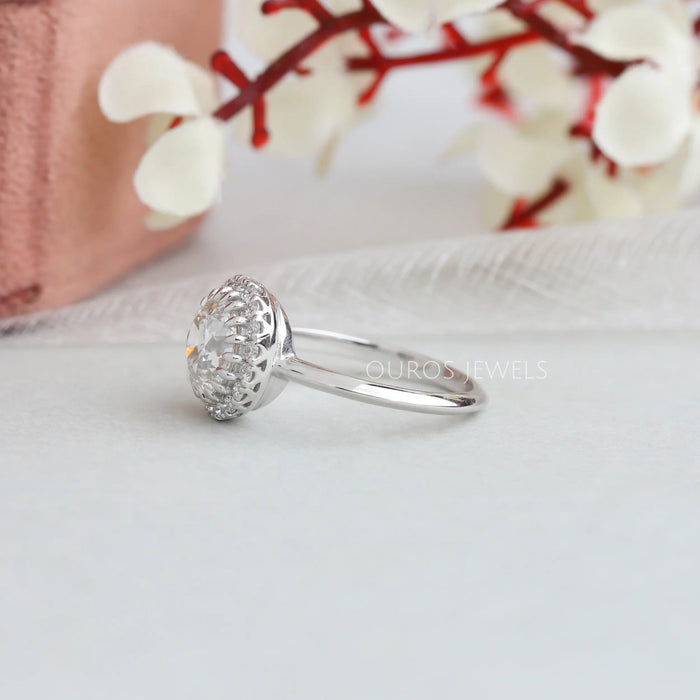 old european round cut diamond halo solitaire ring white gold on model's finger
