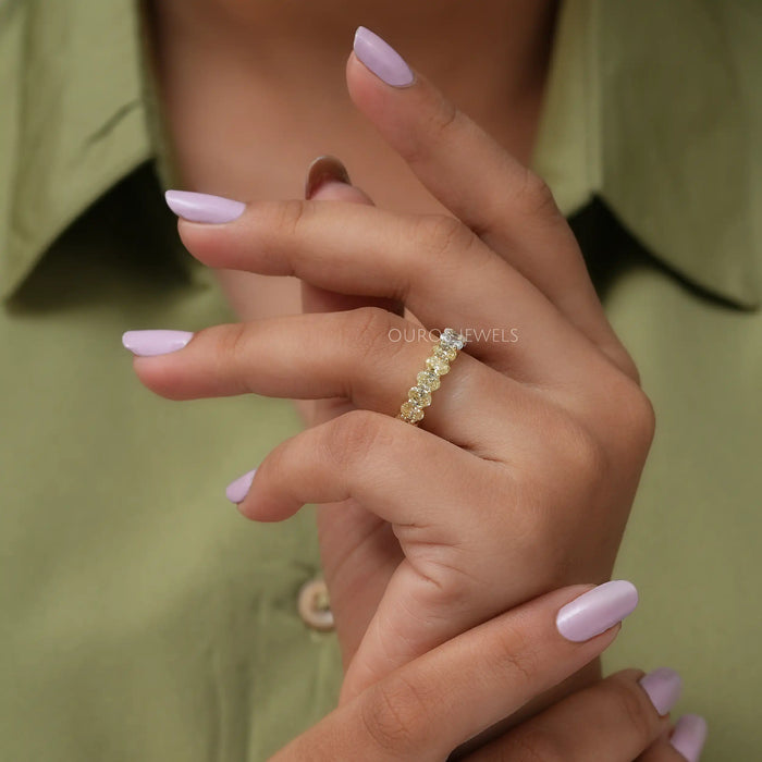 In finger side look of oval shaped lab diamond infinity band