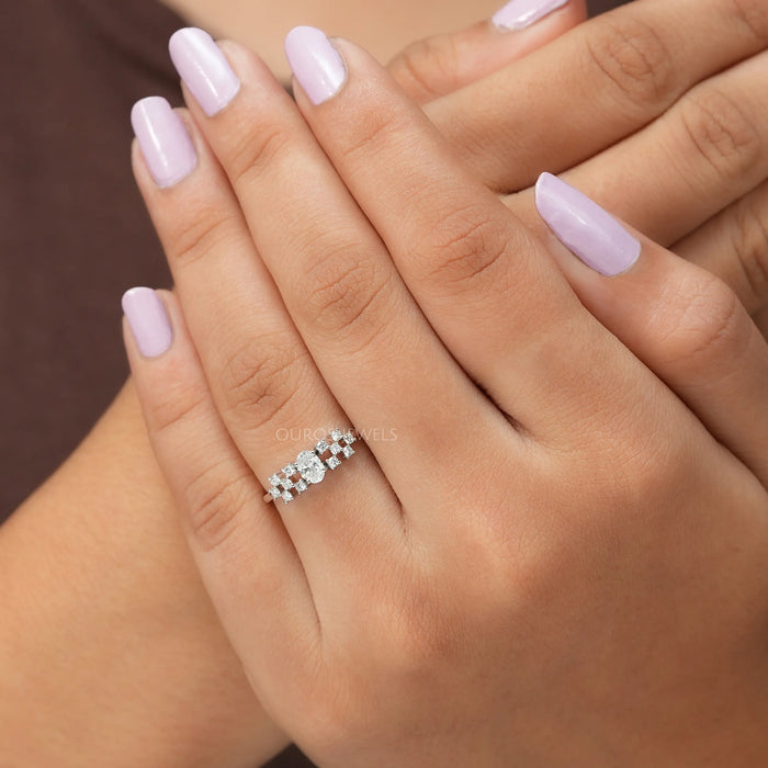 Cross hand front finger view of oval cut cluster diamond ring creates a glamourous look, this ring inspired by vintage style.