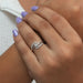 Shining pear shaped lab manufactured diamond engagement ring with bypass style split shank studded with round diamonds