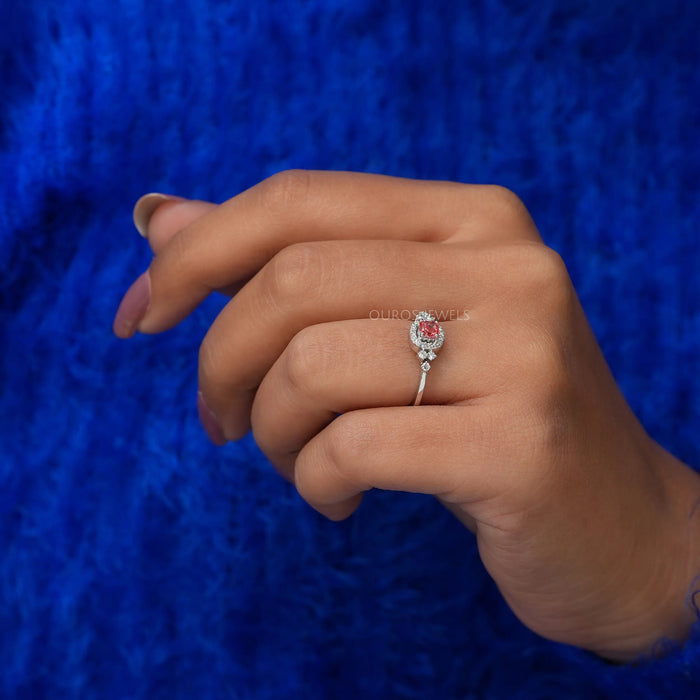 Side view of in finger cushion halo diamond ring