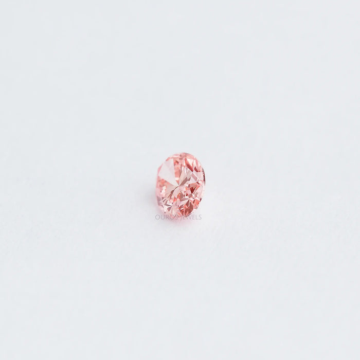 side view of 0.6 carat pink lab created oval diamond loose