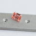 pink emerald cut man made diamond loose on matte material