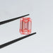 pink emerald cut lab made diamond loose holded by tweezer