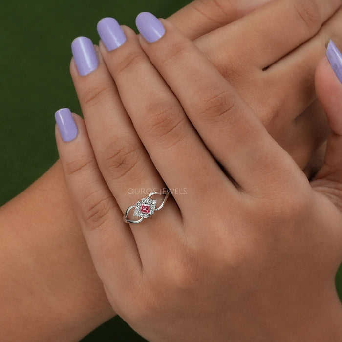 pink princess-cut lab diamond halo split shank engagement ring in finger