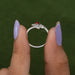 close view of red oval-cut lab-grown diamond bypass colored wedding band
