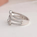 Round accent stones studded on 14k white gold three row shank of pear diamond ring