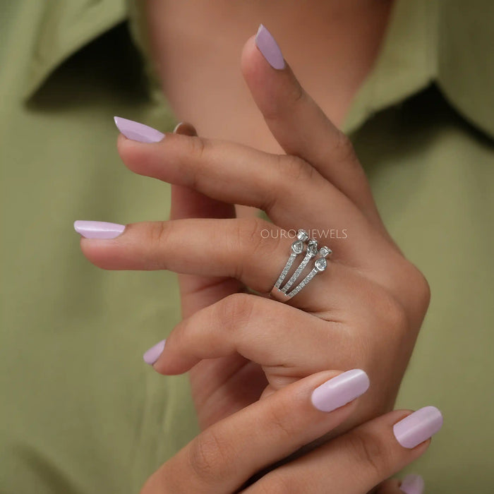 In finger side look of pear shaped three row diamond dainty wedding ring