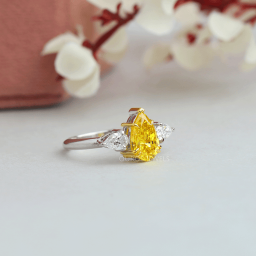 side view of yellow pear cut lab diamond three stone engagement ring