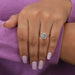 Features a gorgeous pear-shaped blue center diamond, surrounded by a halo of smaller diamonds that accentuates its beauty