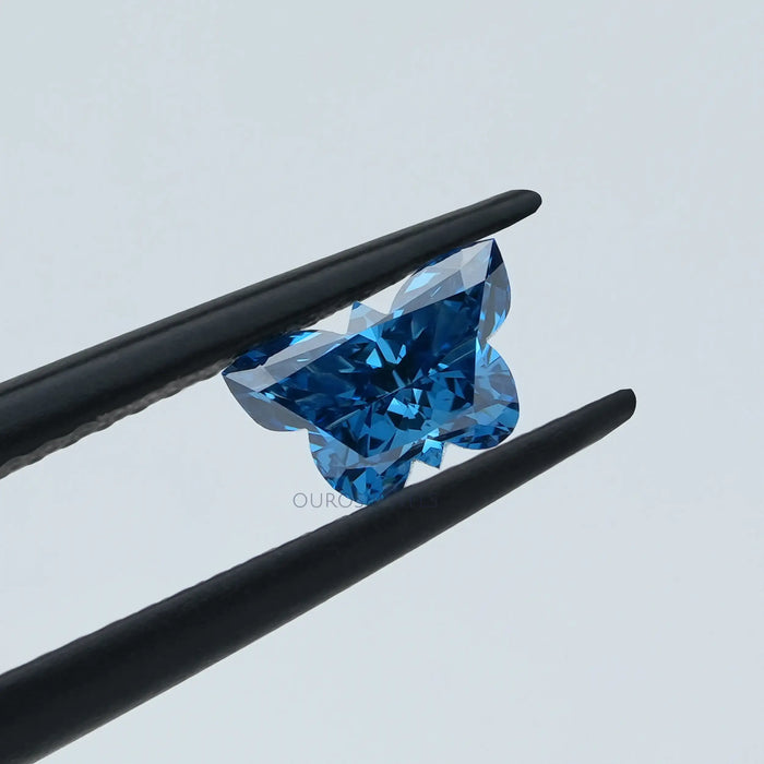0.55 carat blue butterfly cut lab created diamond loose holded with tweezer