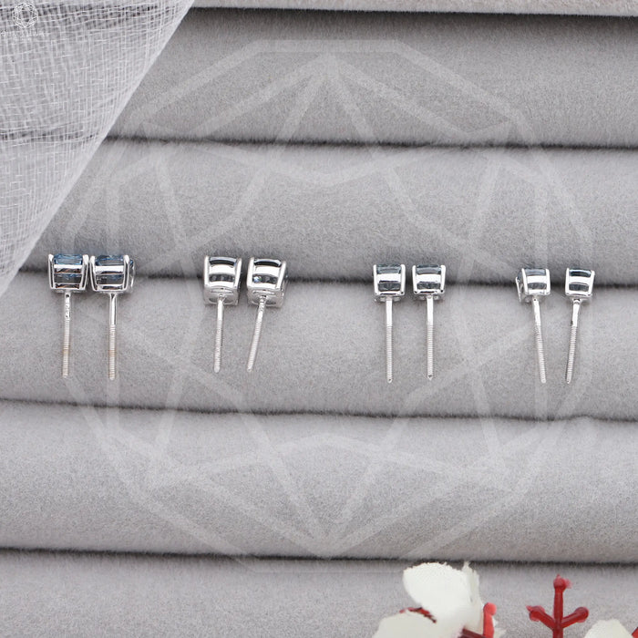 back view of blue cushion cut lab made diamond stud earrings white gold on box