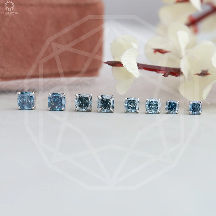 top view of blue cushion cut lab created diamond stud earrings white gold