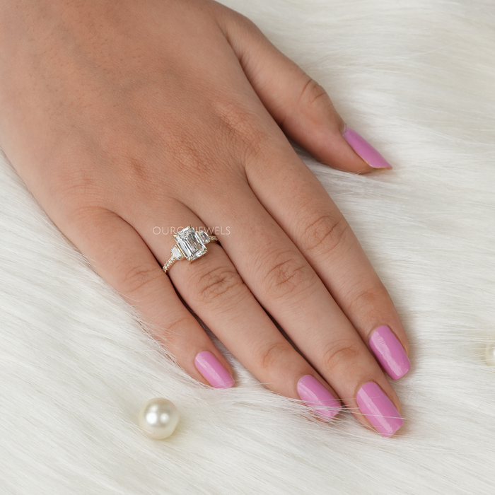 criss cut diamond three stone engagement ring with yellow gold band in finger