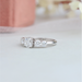 side view of round-cut diamond bezel-set curved wedding band with white gold band