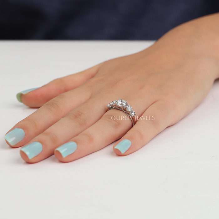 round-cut diamond bezel-set curved wedding band with white gold band in finger