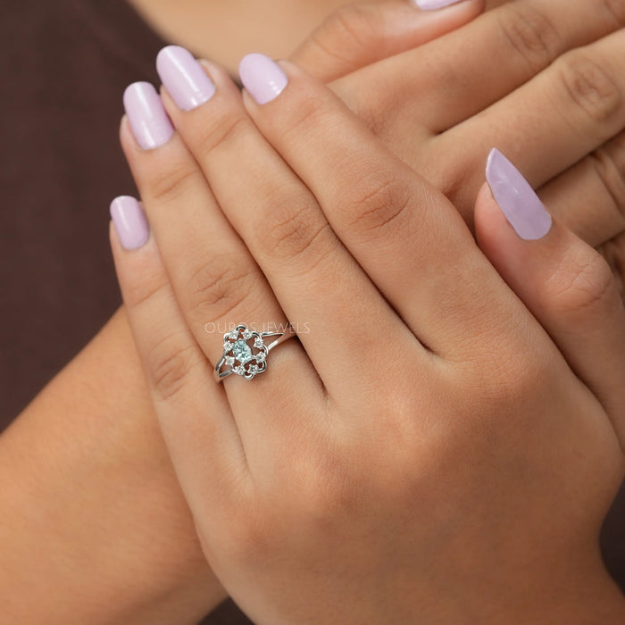 Cross hand front finger view of oval shaped diamond engagement ring with VS charity..