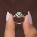 This floral engagement ring made of 14k white gold, center stone green oval crafted with VS clarity.