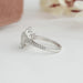 heart cut lab diamond halo engagement ring's side angle view on grey fabric